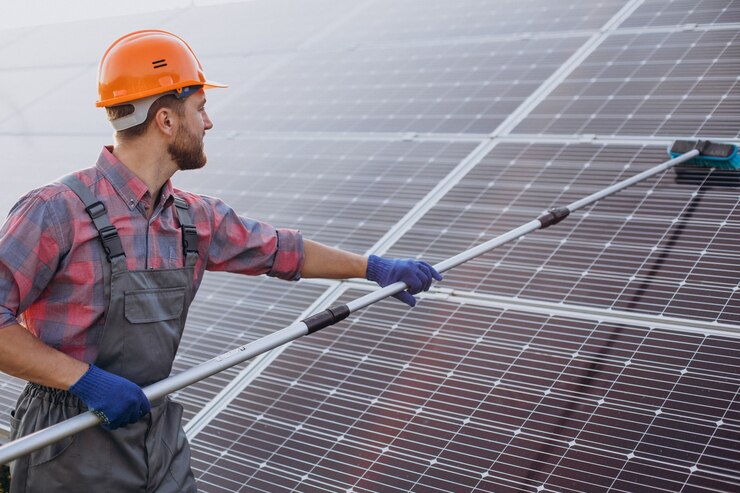 male-worker-cleaning-solar-panels